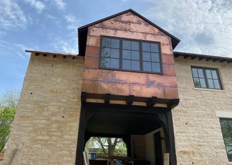 Copper metal panel facade on a stone building for Skylight Installation in Midwest City